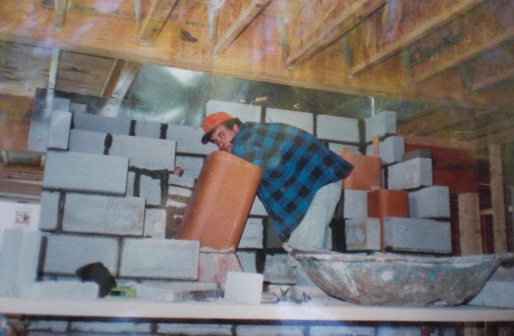 man completing fireplace work