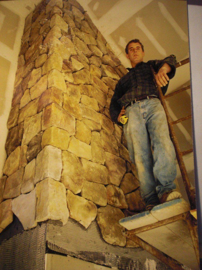 man by decorative block wall