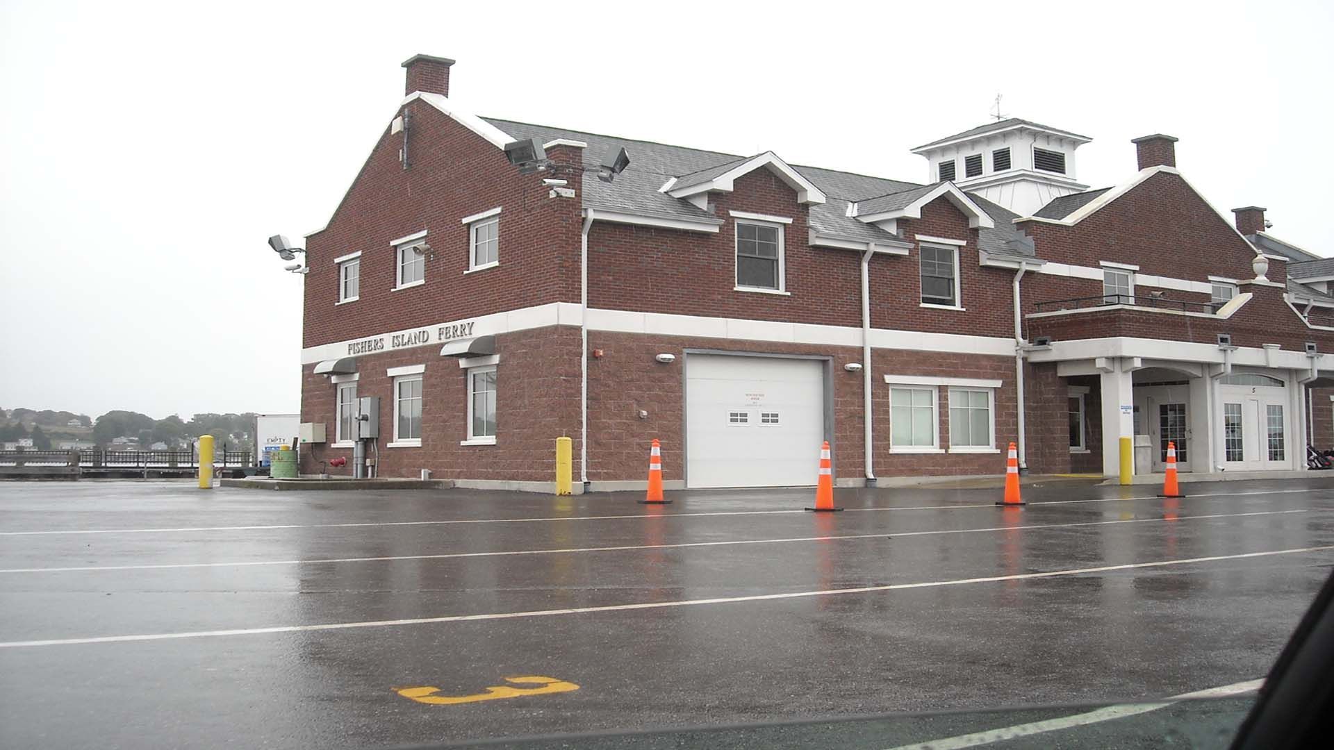 Red brick building with white trim and garage door on a wet, gray day.
