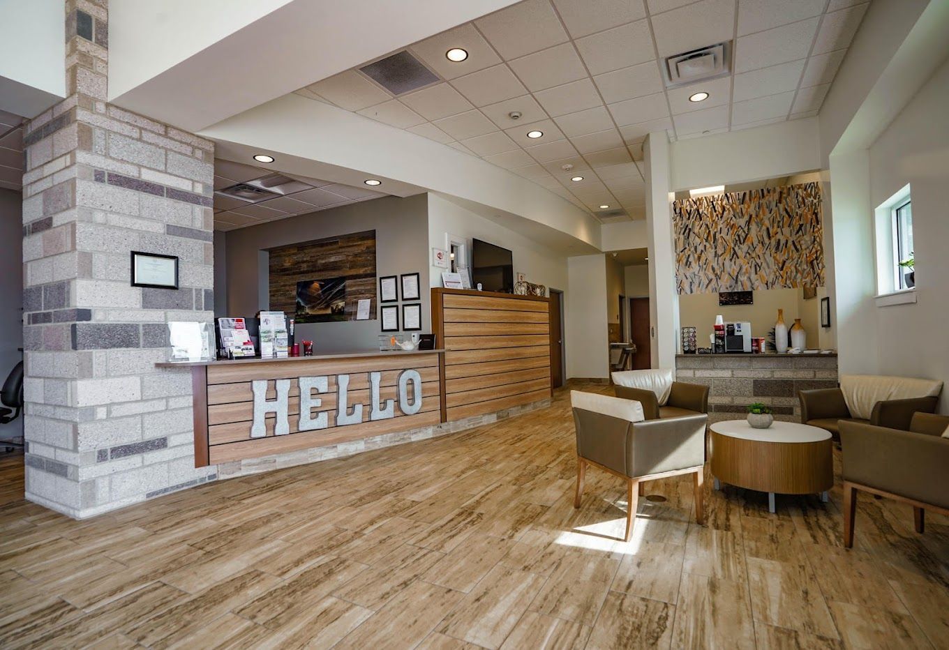 A lobby with a wooden floor and a Hello sign
