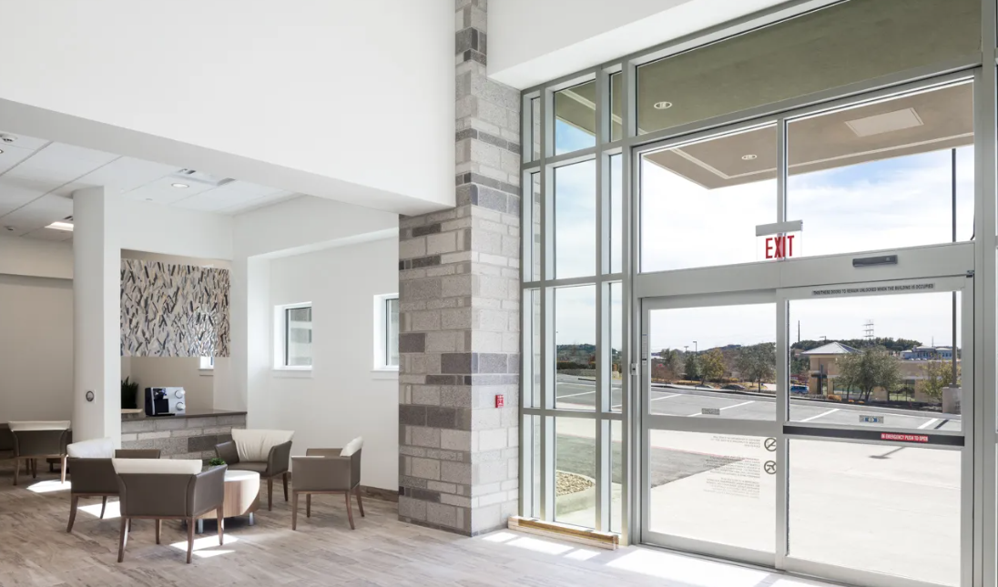 A large room with a lot of windows and a sliding glass door.