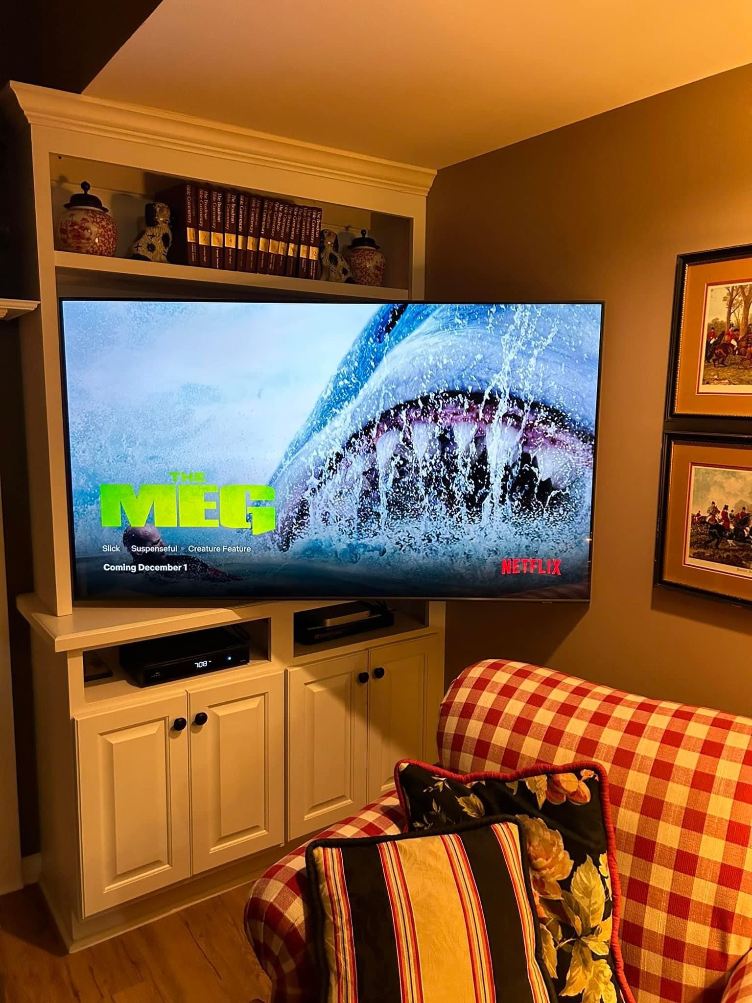 A living room with a couch and a flat screen tv.