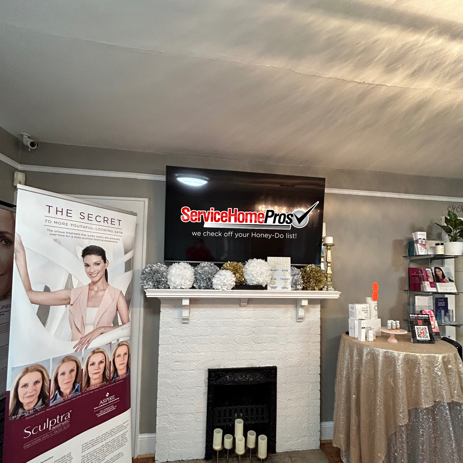 A living room with a fireplace and a sign that says service home pros