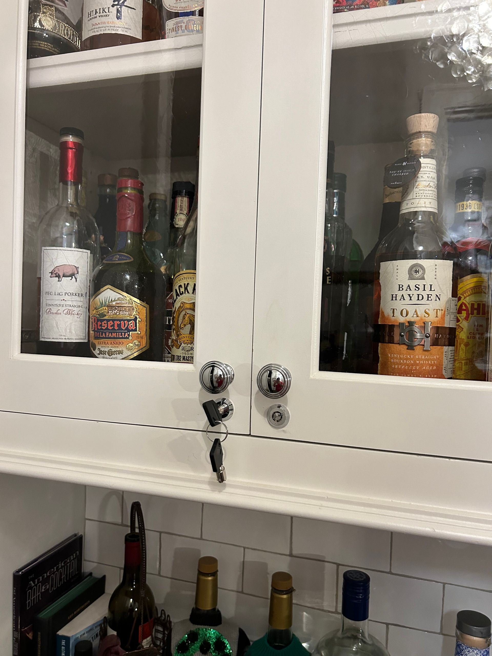 A cabinet filled with lots of bottles of alcohol.