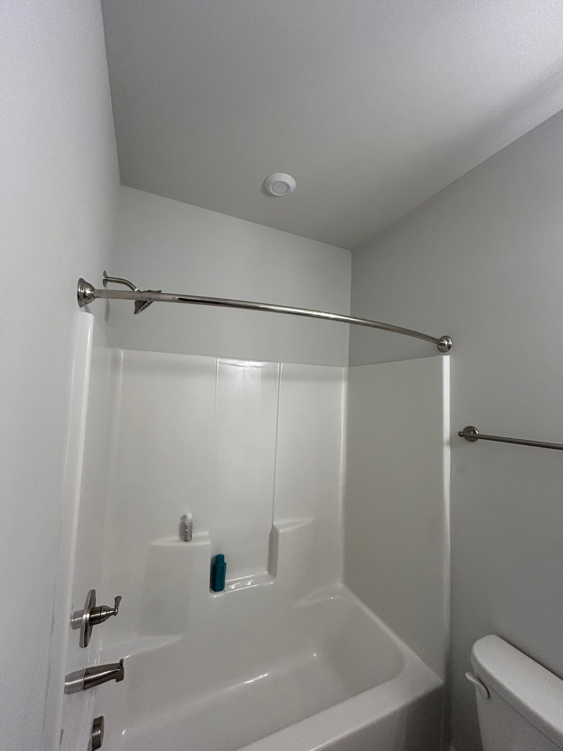 A bathroom with a bathtub and a toilet.