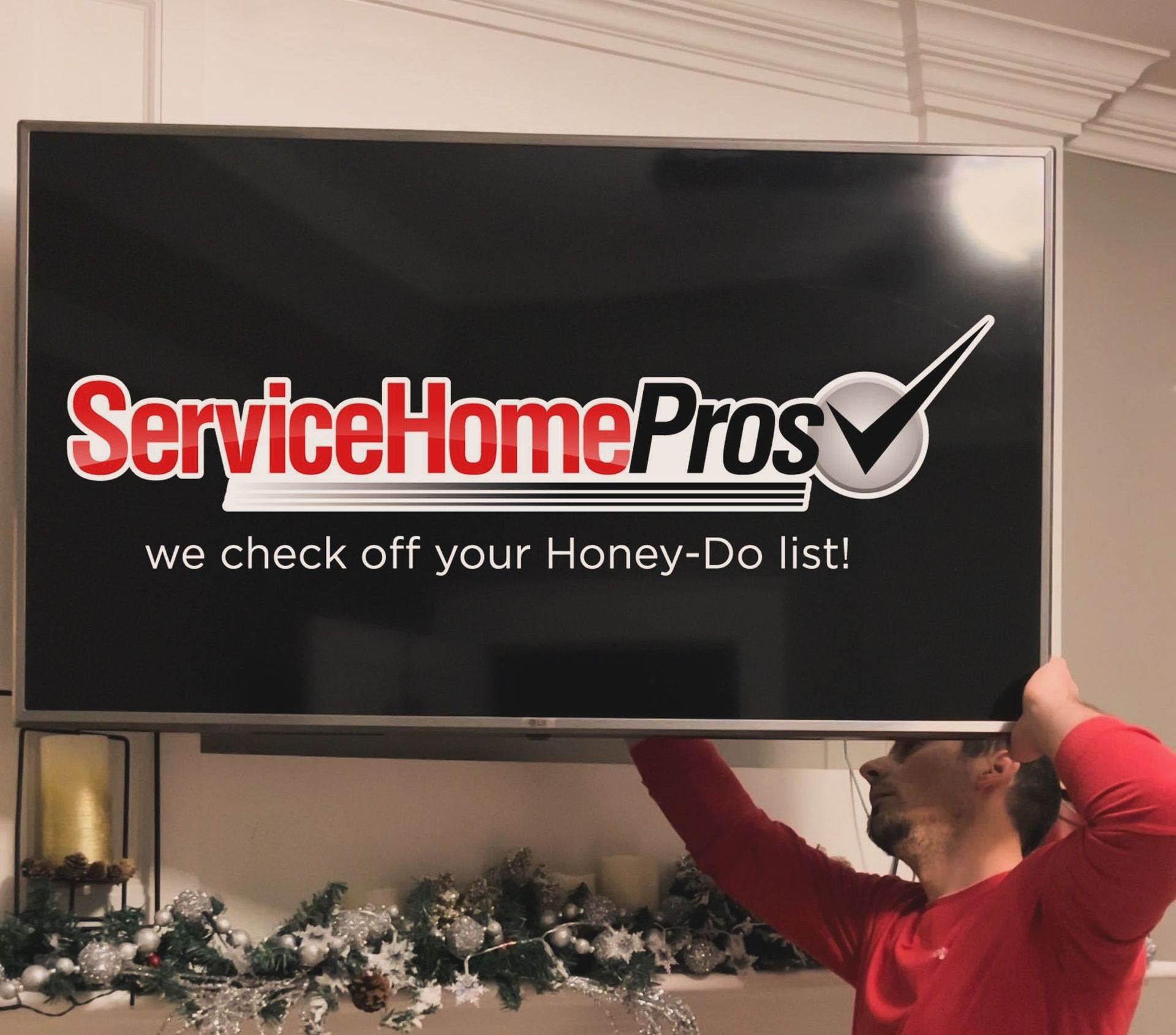 A man is holding up a service home pros sign