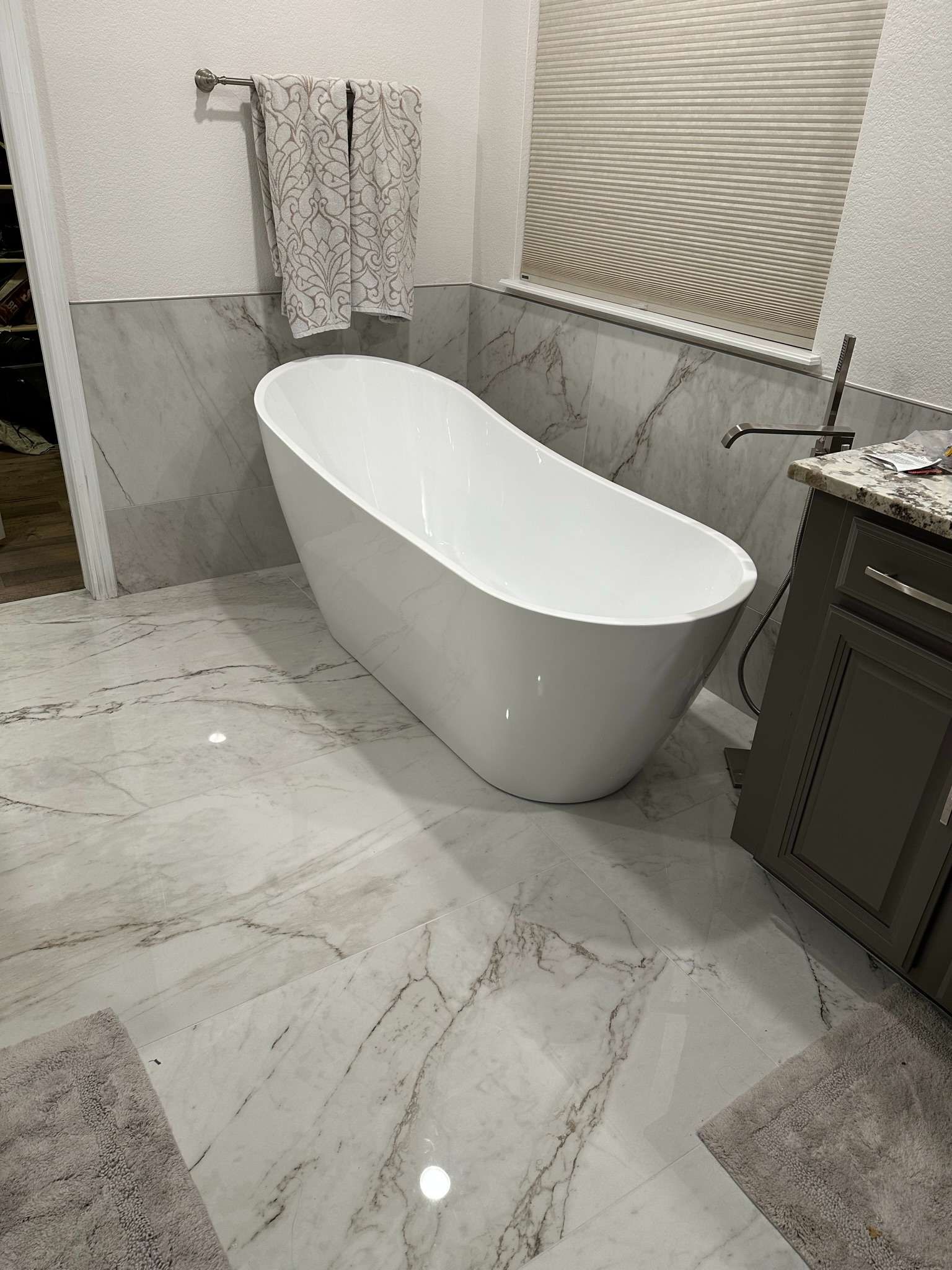 There is a bathtub in the middle of the bathroom.