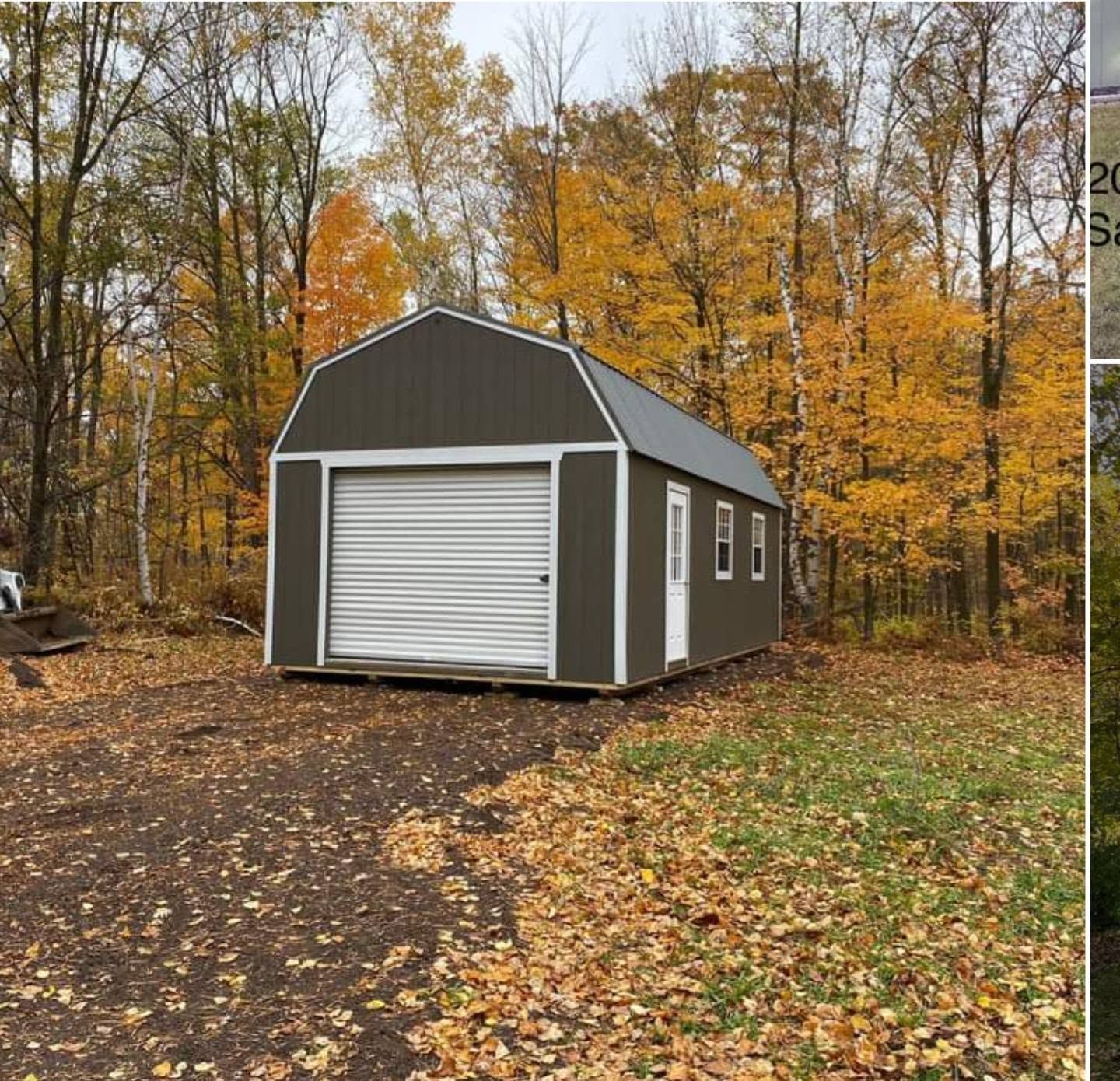 Gray storage shed with white roll-up door in a wooded yard during autumn