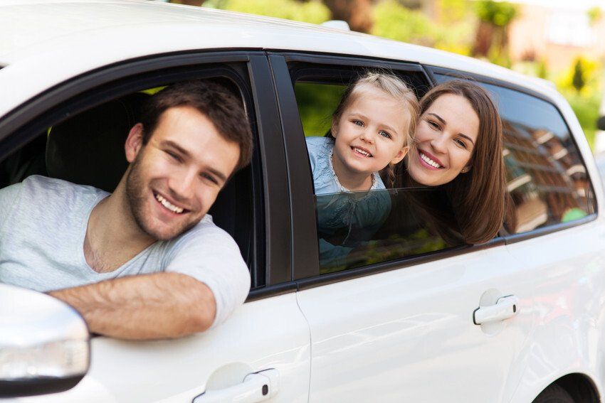 happy family riding a car