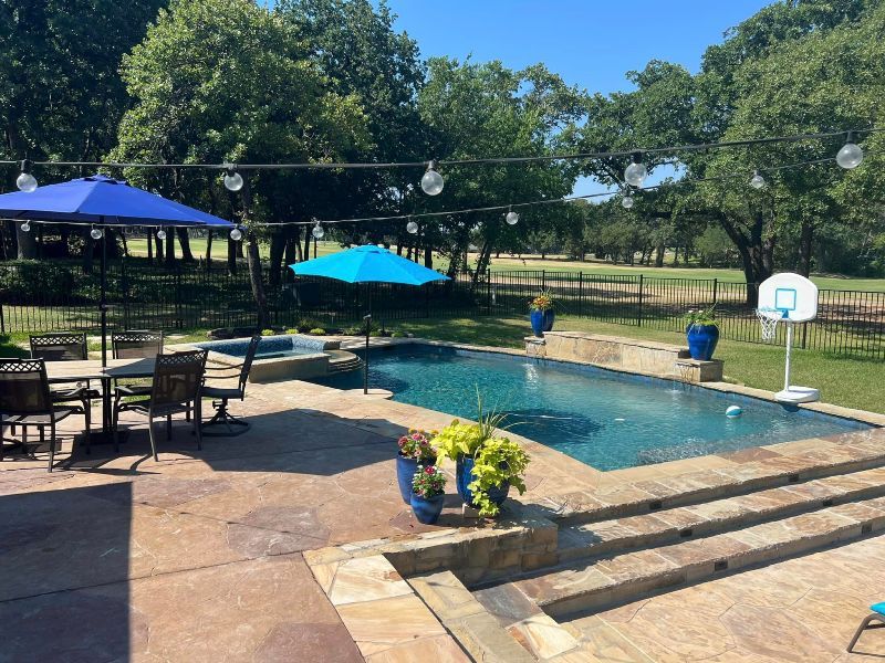 A large swimming pool with a basketball hoop in the backyard