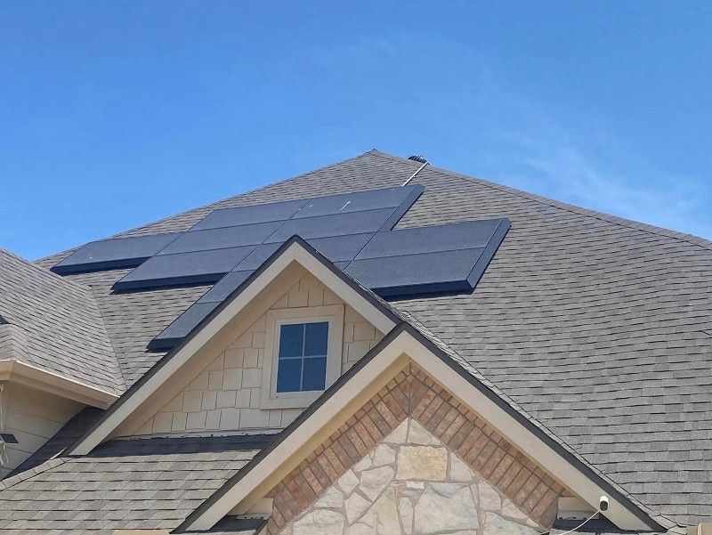A house with solar panels on the roof and a window