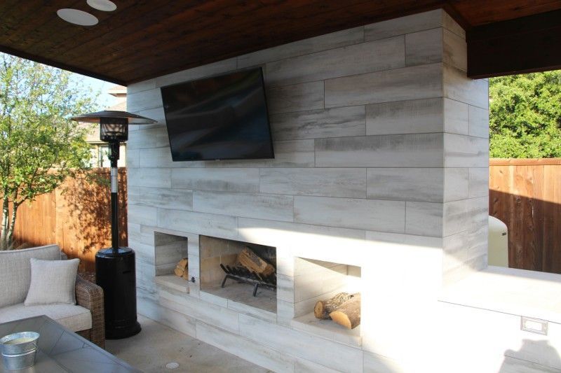 A living room with a fireplace and a flat screen tv.