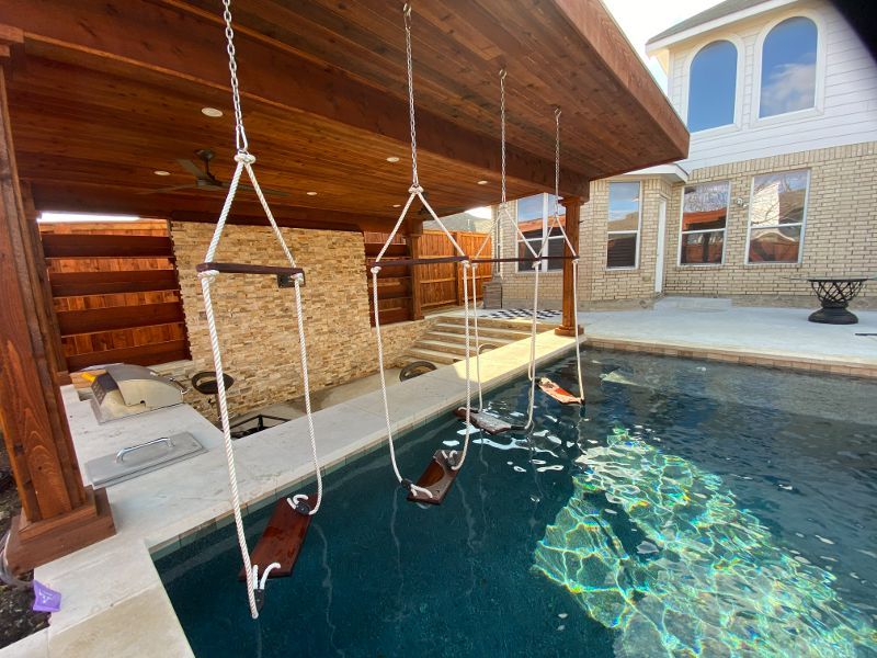A swimming pool with swings hanging from the ceiling