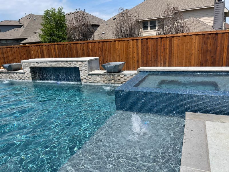A large swimming pool with a wooden fence surrounding it