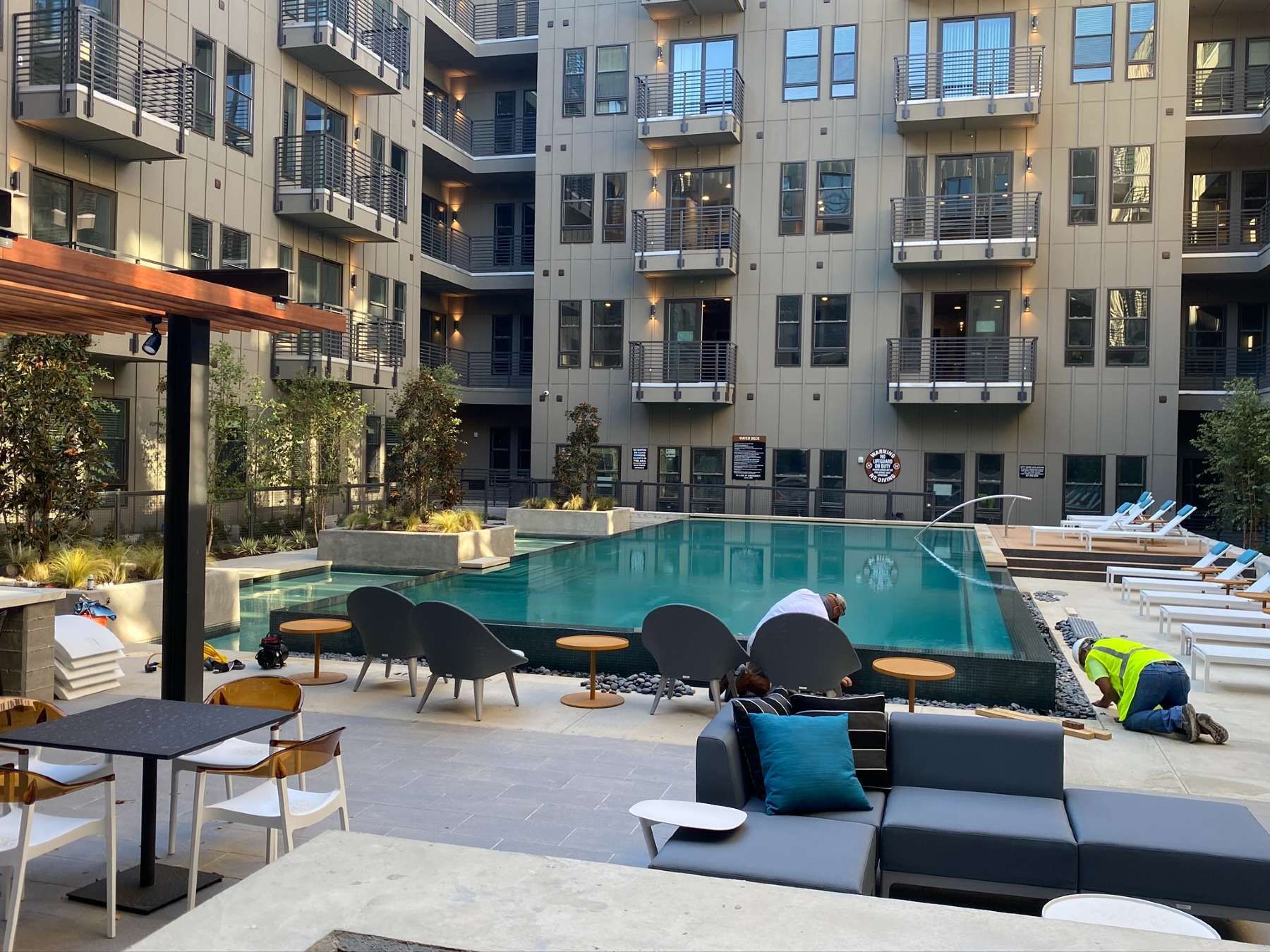 A large building with a swimming pool in the middle of it