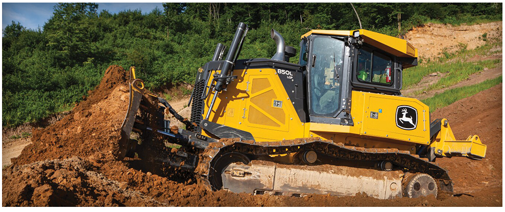 Yellow John Deere bulldozer pushing dirt uphill