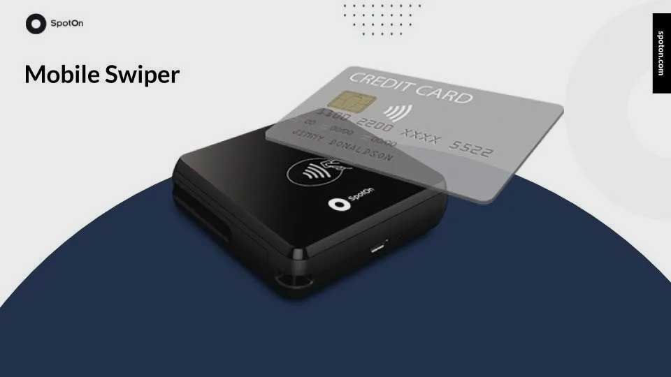 Black mobile swiper with a credit card on top.