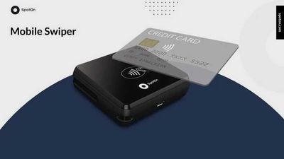 Black mobile swiper with a credit card on top.