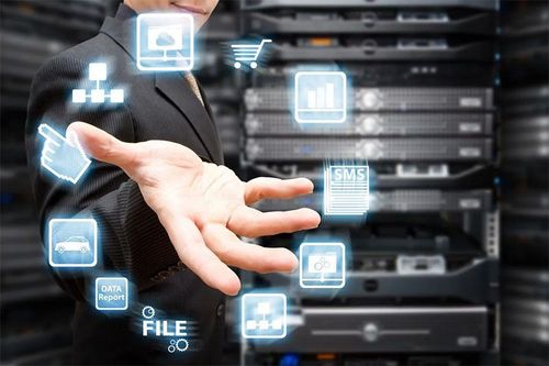 A person in a suit stands before server racks, gesturing toward glowing digital icons representing cloud and data services.