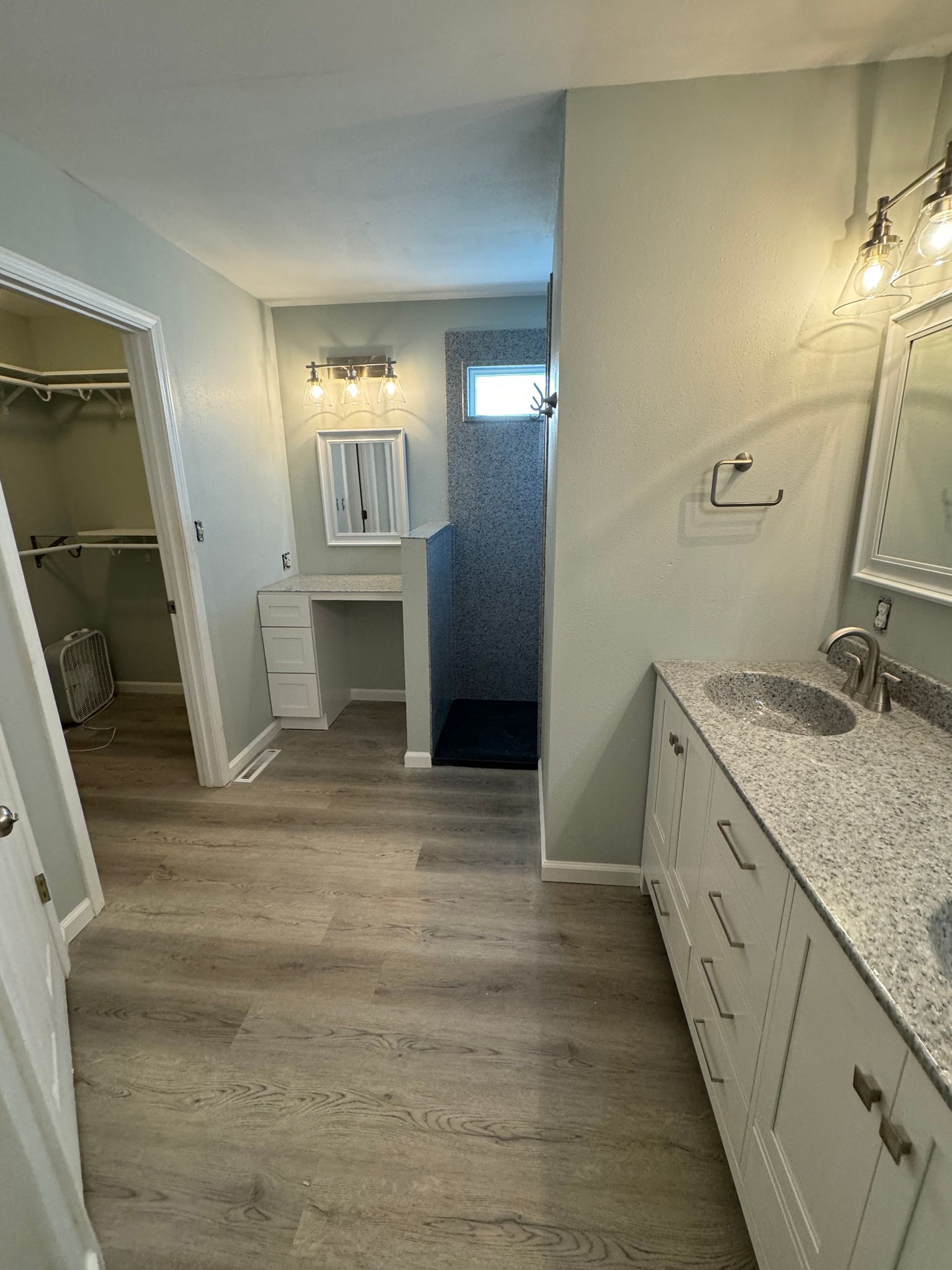 A bathroom with two sinks and a walk in shower