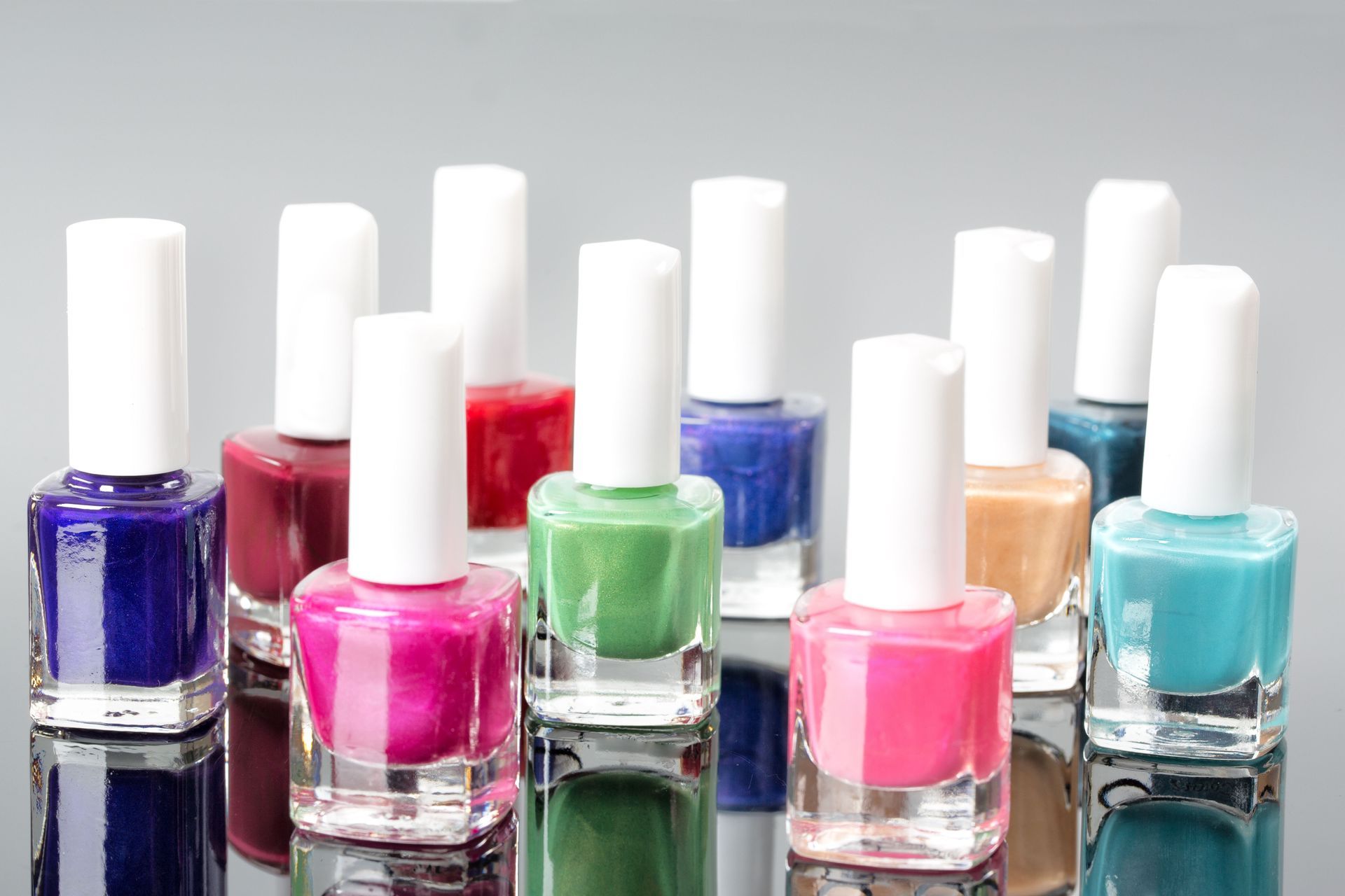 Gloved hands examining scalp with a small device on dark hair roots in a clinic setting.