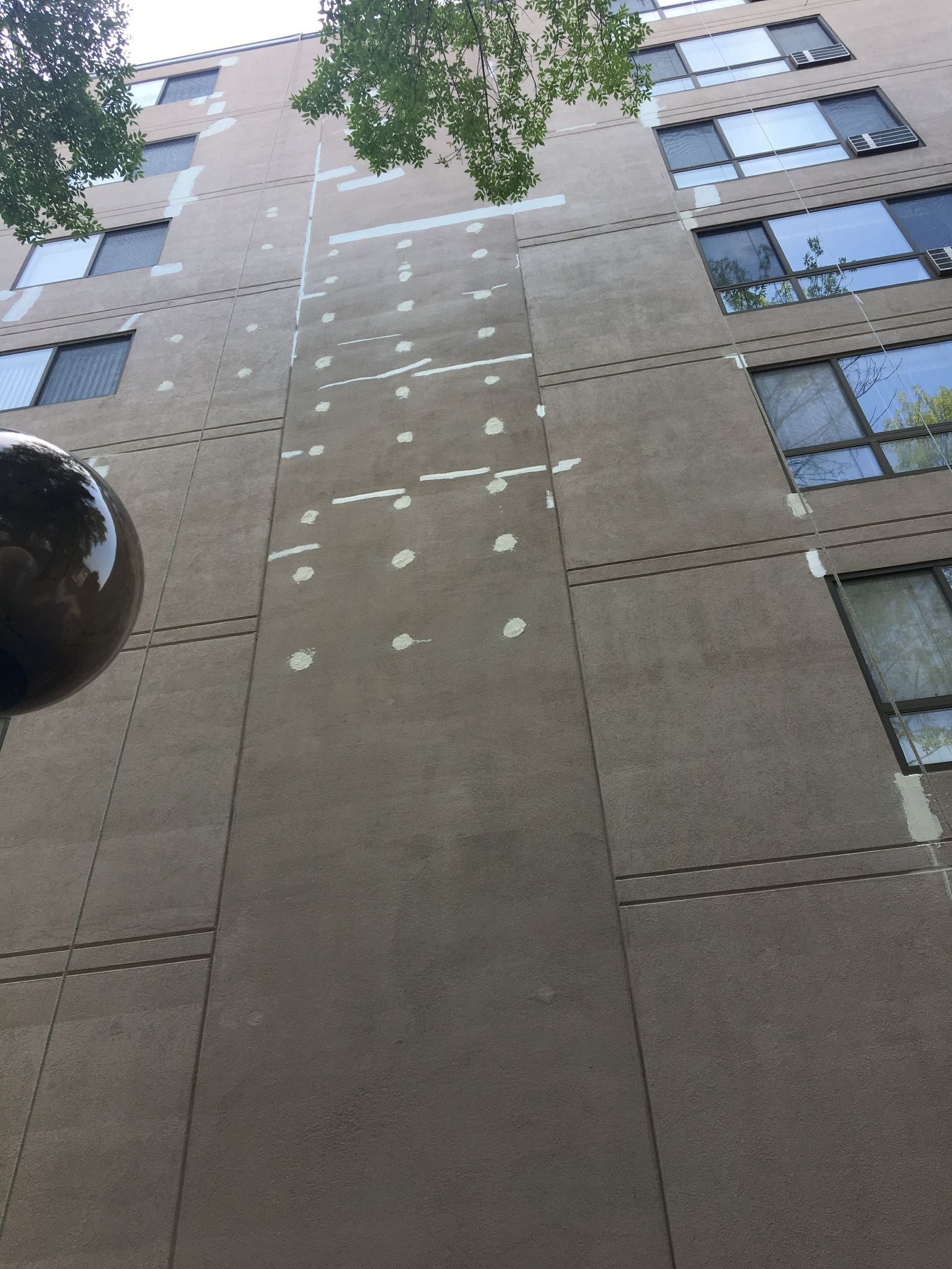 Looking up at a tall building with many windows
