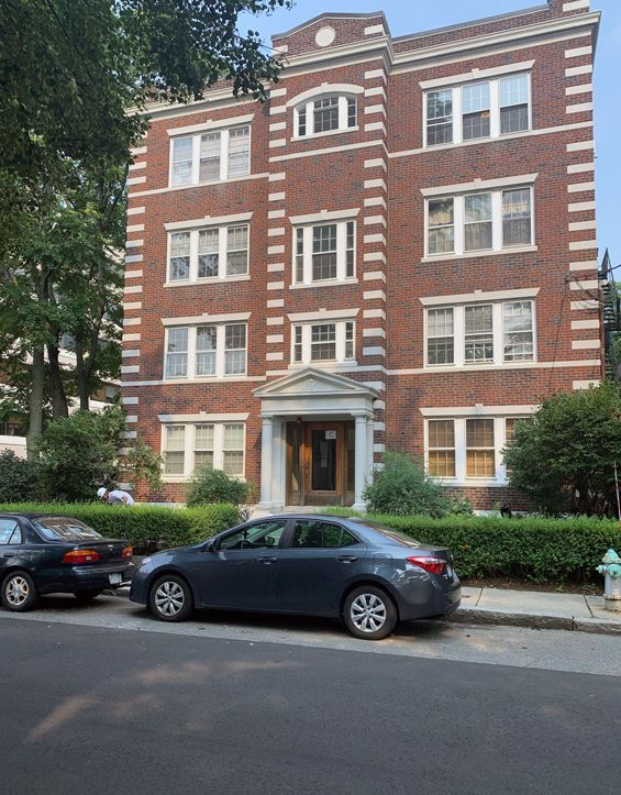 A brick building with cars parked in front of it