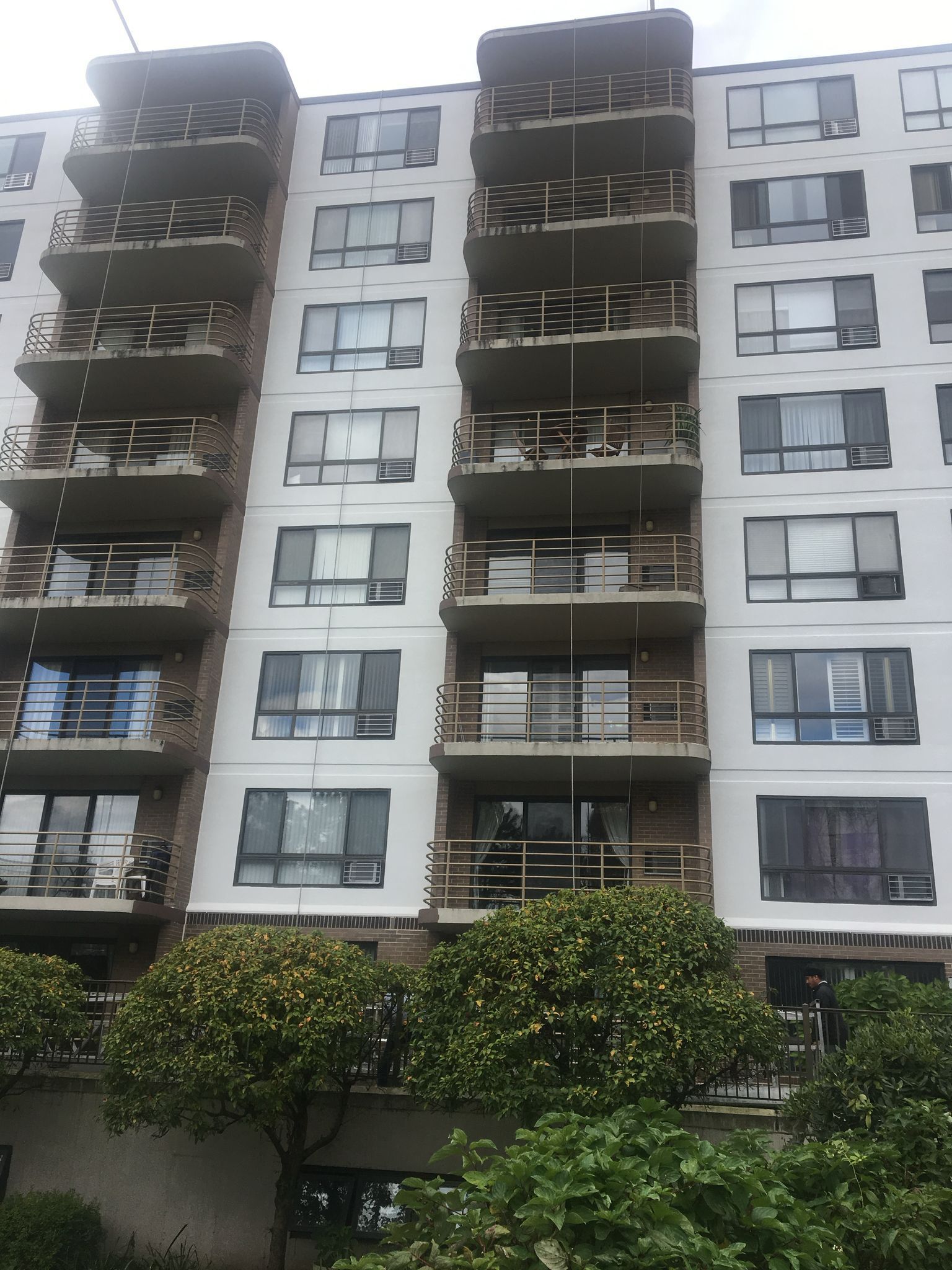 A tall building with a lot of windows and balconies