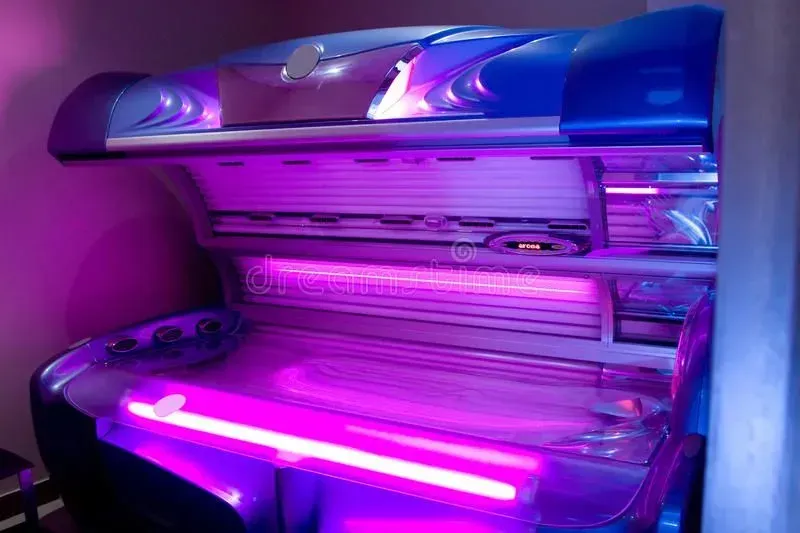 Blue and silver tanning bed with purple lights.