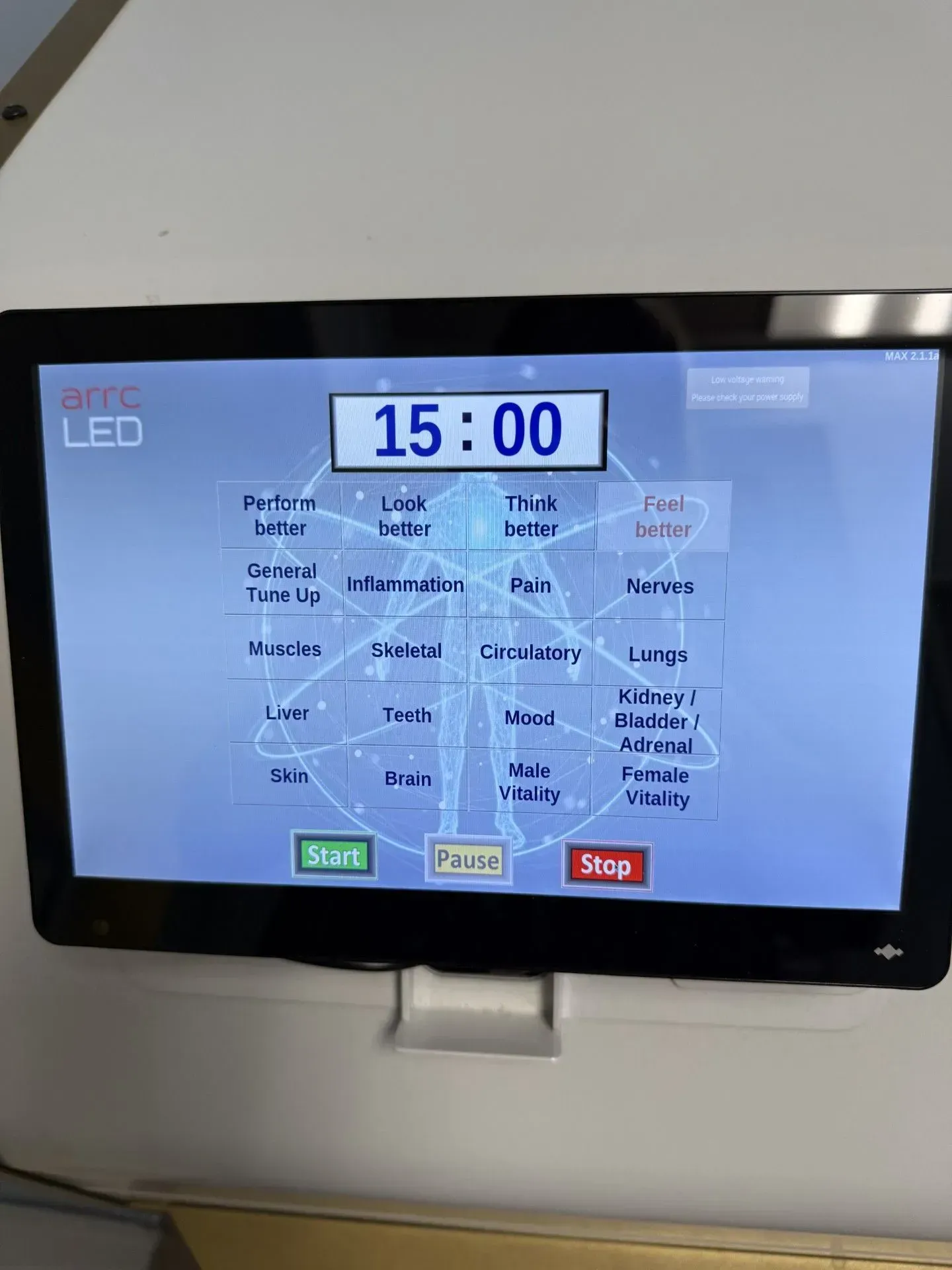 Touchscreen panel with a 15:00 timer, various body system options, and start/pause/stop buttons.
