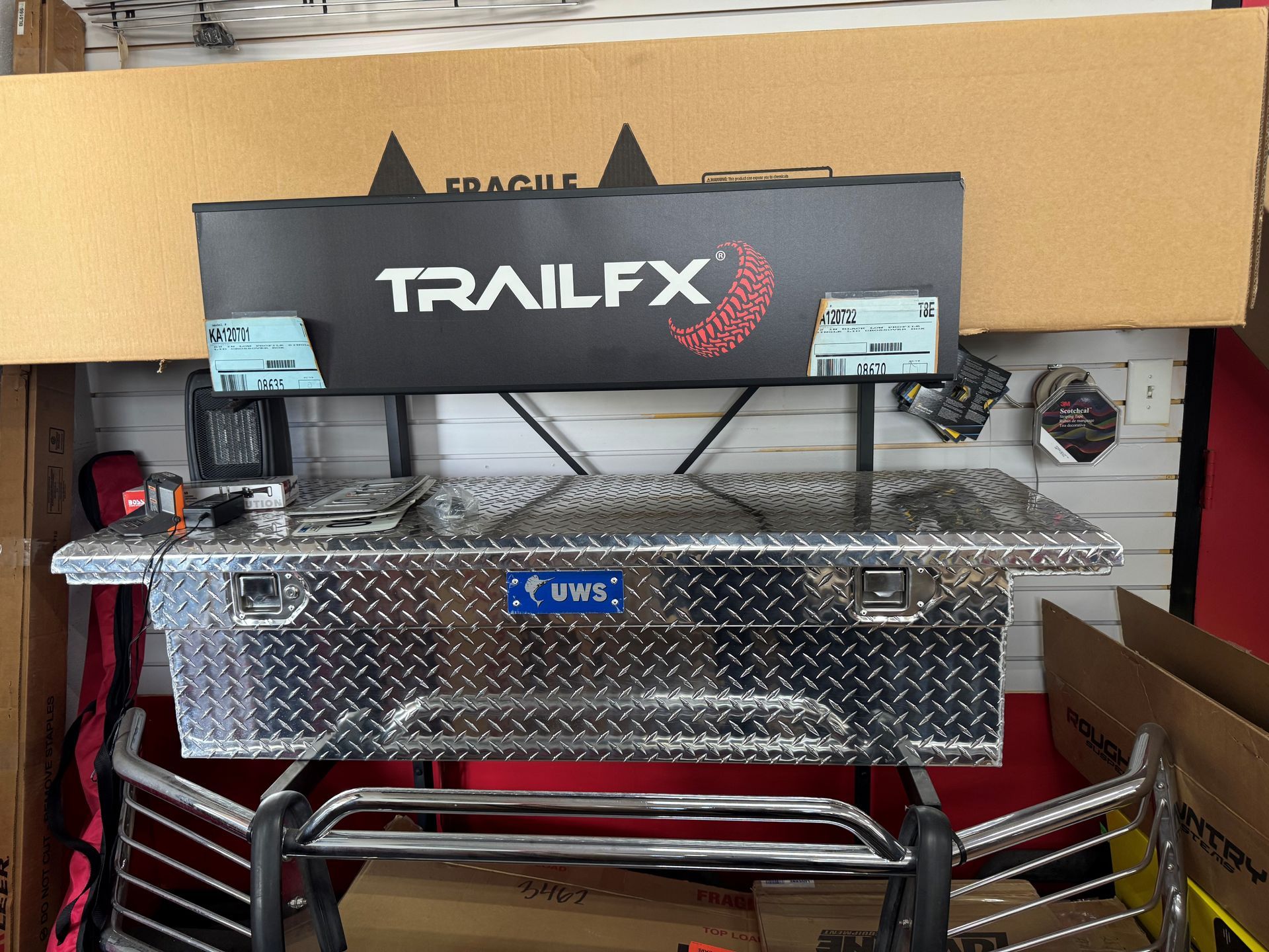 TrailFX black hitch box mounted on a diamond-plate truck tool chest in a garage