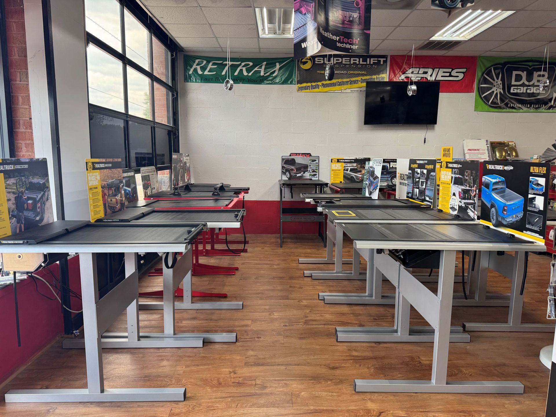 Empty hobby shop with display tables and model kits in a bright room