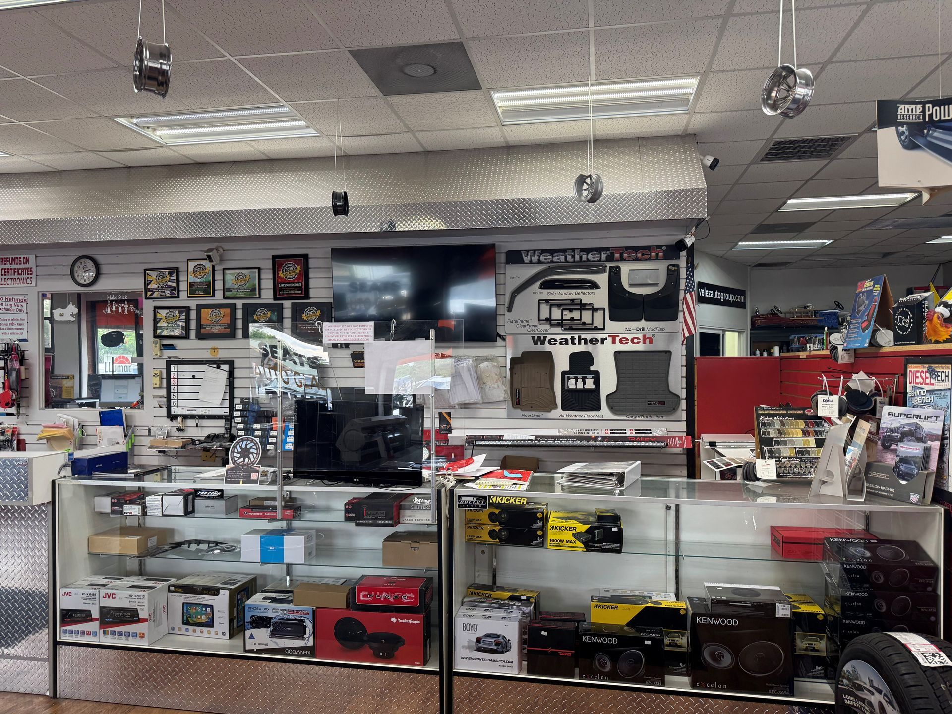 Electronics store counter with boxed car audio and accessories on display shelves