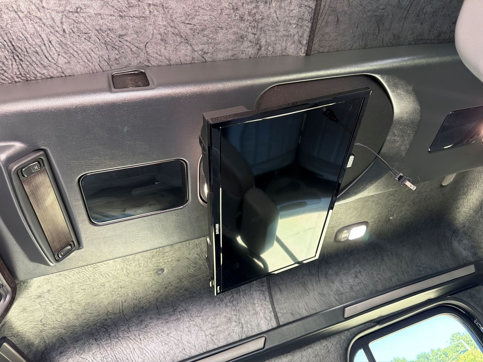 Open glove compartment in gray car dashboard with blue interior compartments