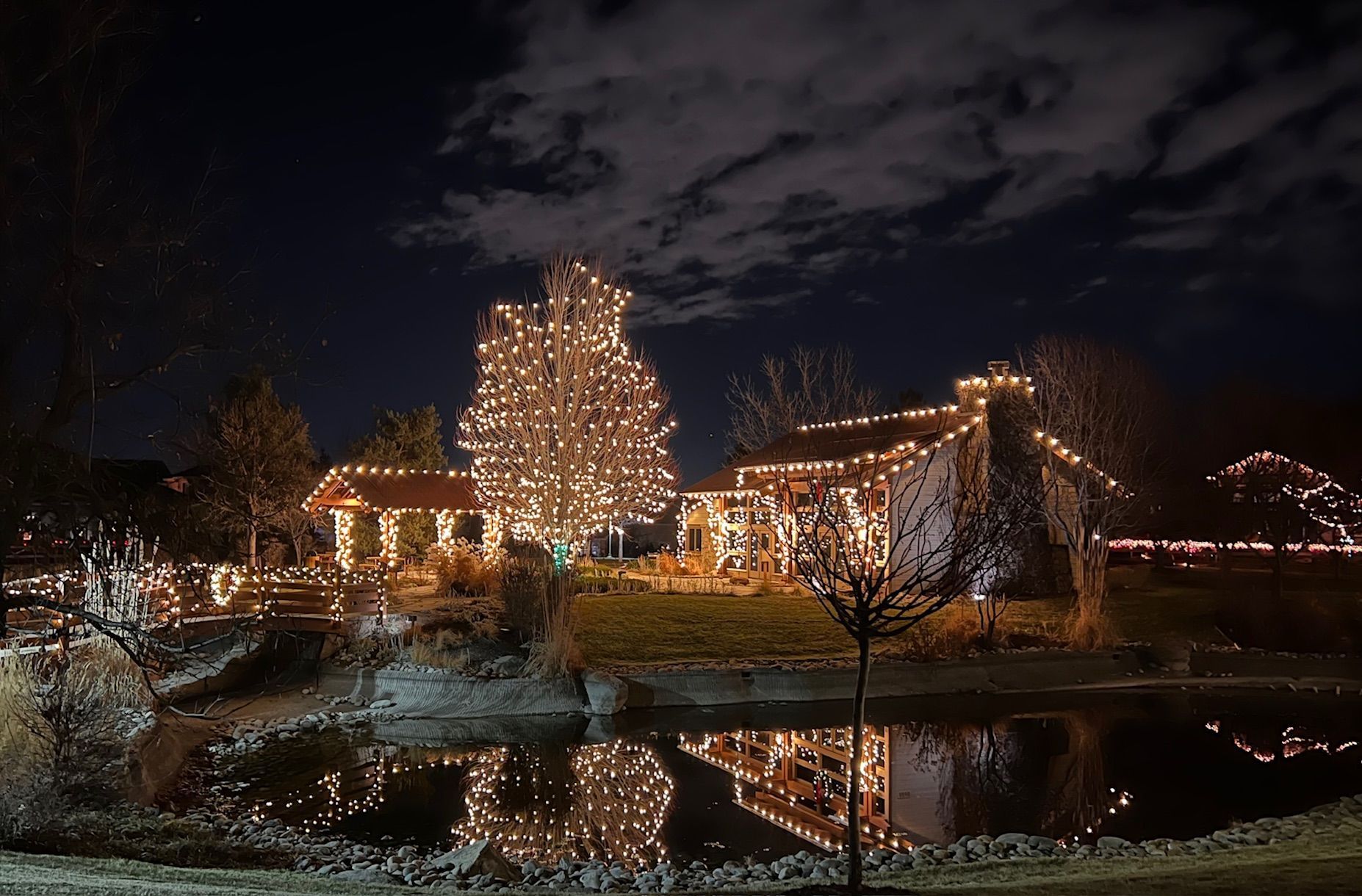 a house is lit up with christmas lights at night