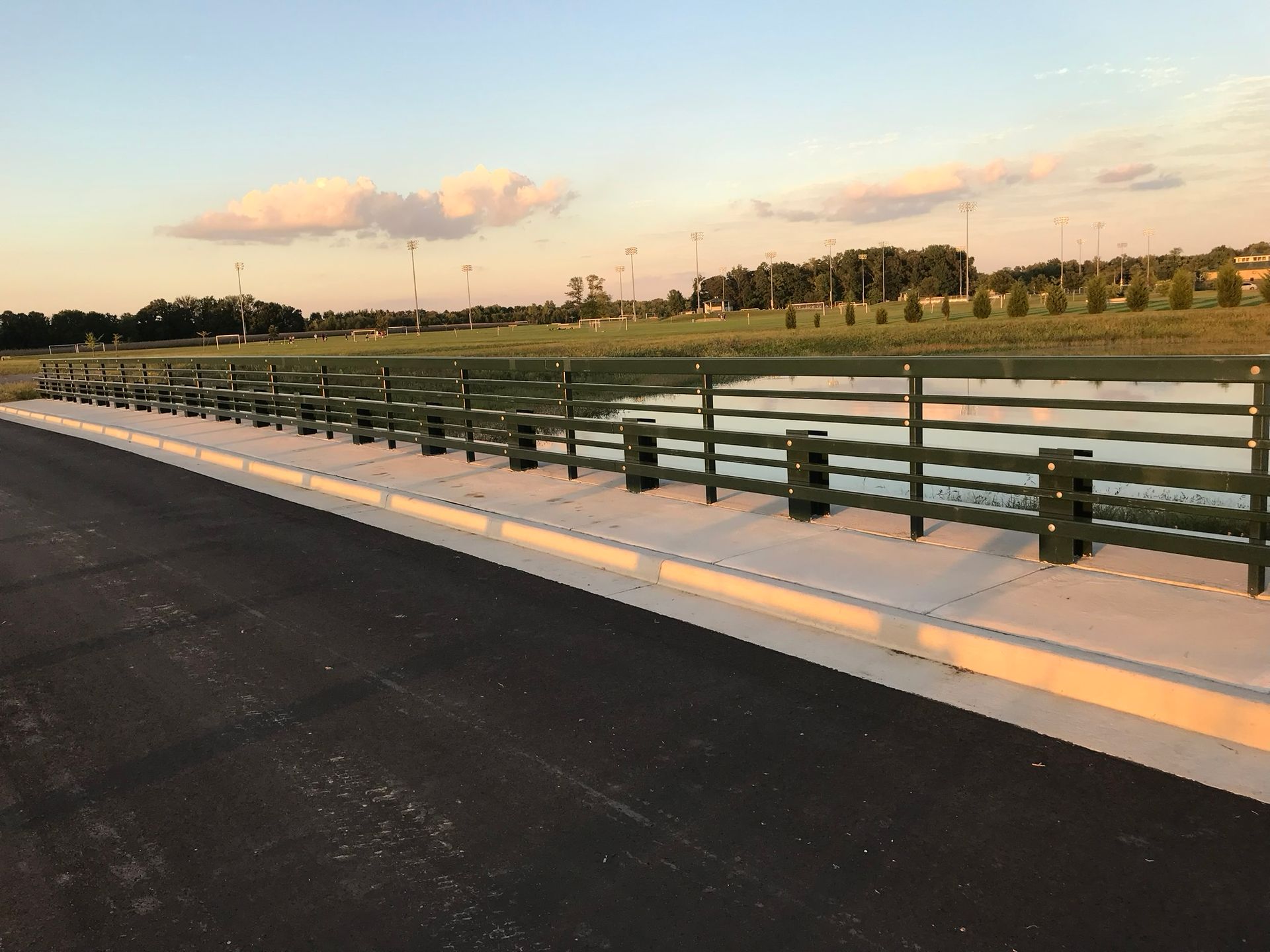 A bridge over a body of water with a fence around it