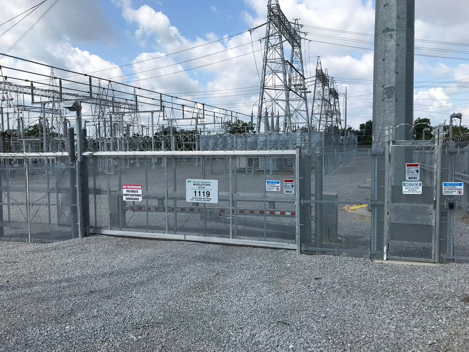 A sliding gate is surrounded by a chain link fence.