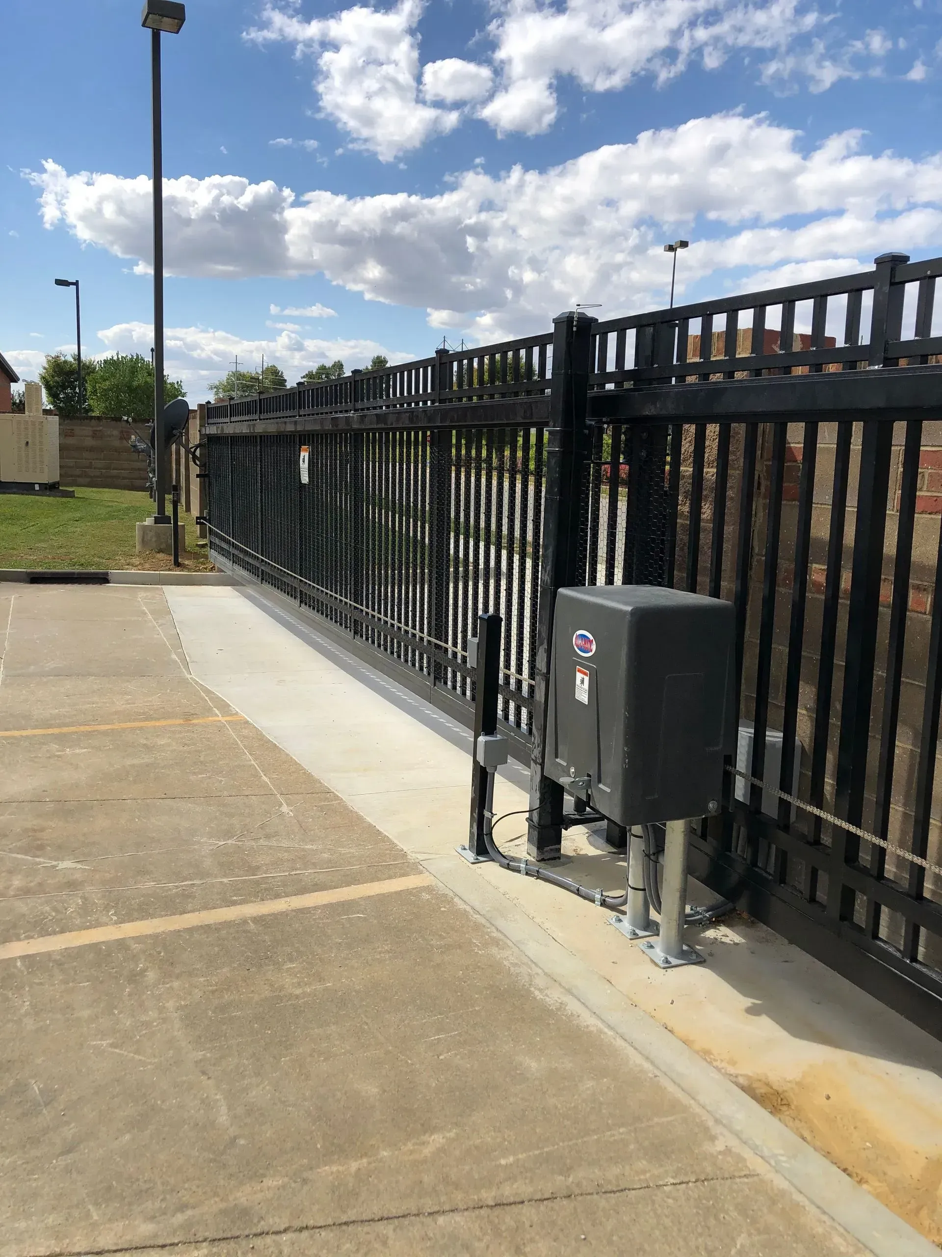 A sliding gate with a box on the side of it