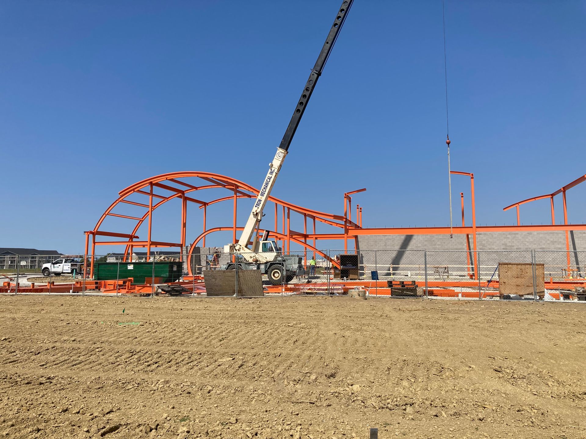 A construction site with a crane in the middle of it
