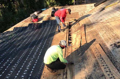 Professional roofers installing roof