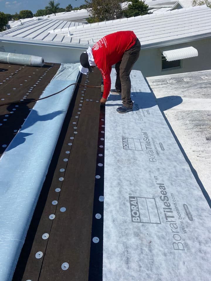 man in red installing the roof underlayment
