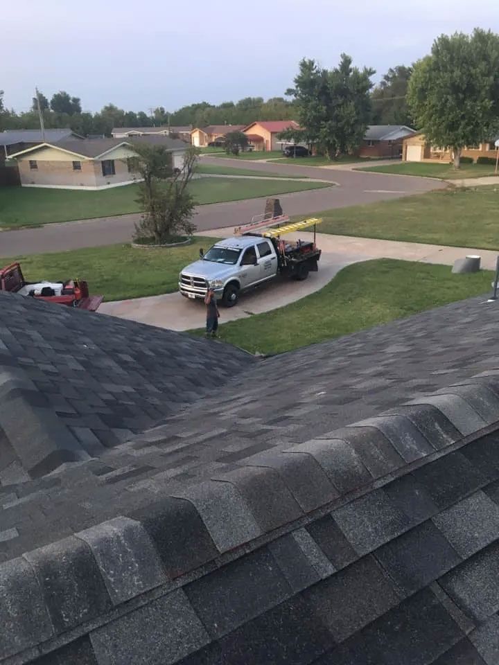 A truck is parked on the roof of a house.