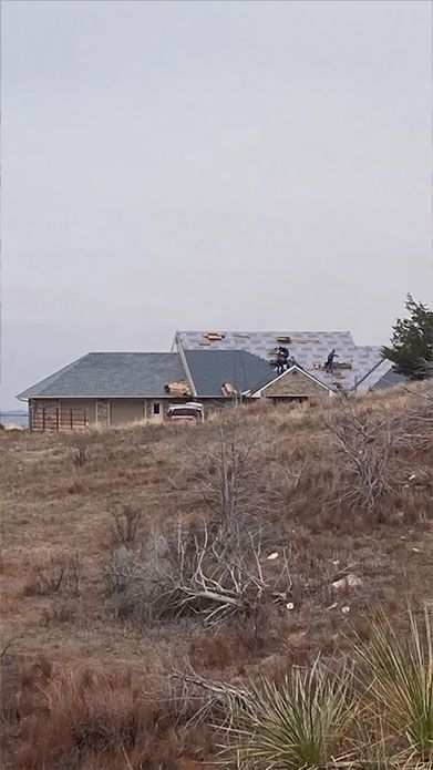 A house is being built in the middle of a field.