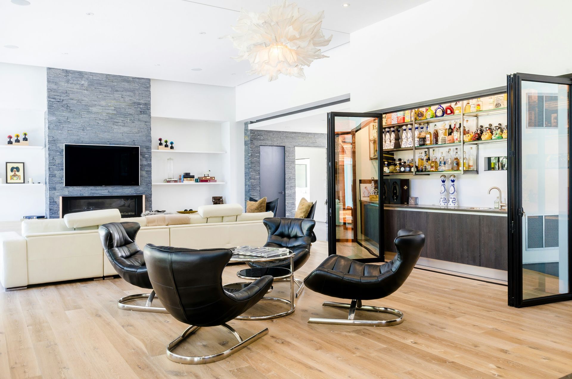 a living room filled with furniture and a bar