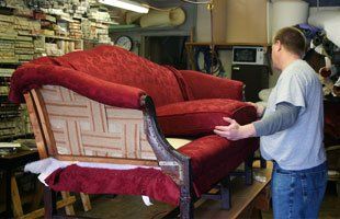 Upholsterer working on a sofa