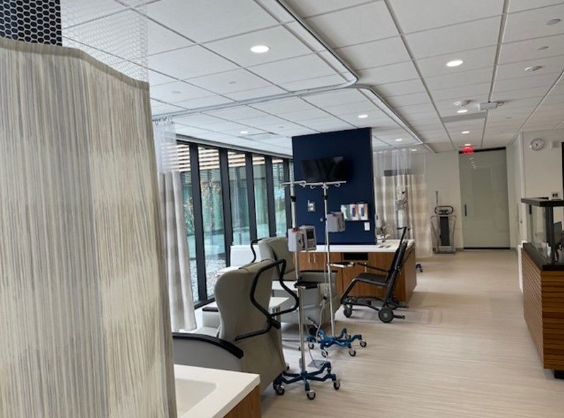 A hospital room with a lot of windows and chairs