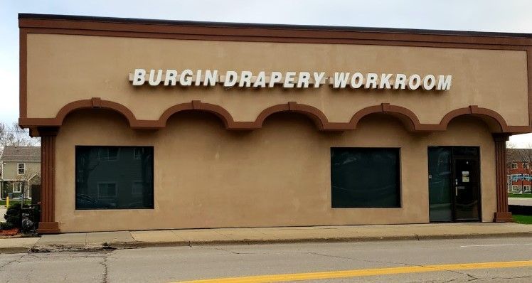 A building with a sign that says burgin drapery workroom