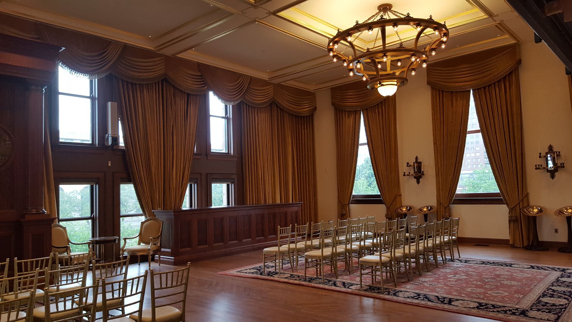 A large room with rows of chairs and a chandelier.