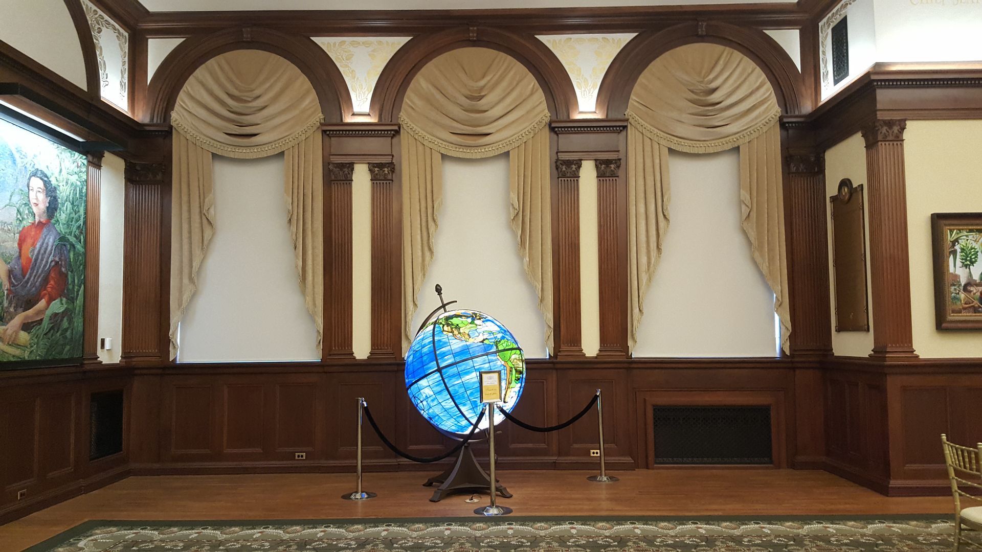 A room with a globe in the middle of it