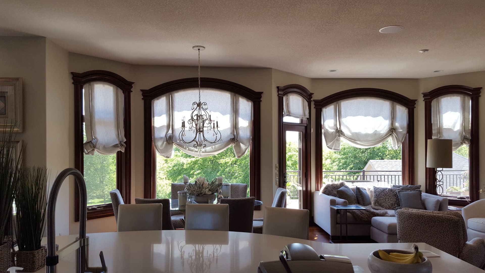 A kitchen with a sink and a lot of windows